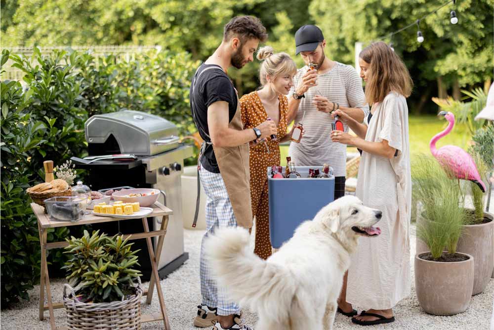 Family with a white dog at a bbq